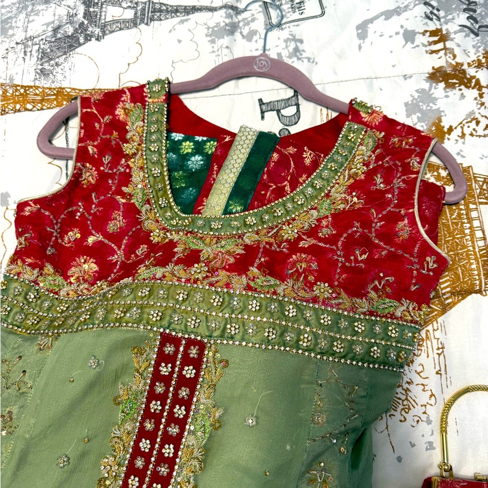 Red and Green Embroidered Sleeveless Top with green banaras Lenga pants.
